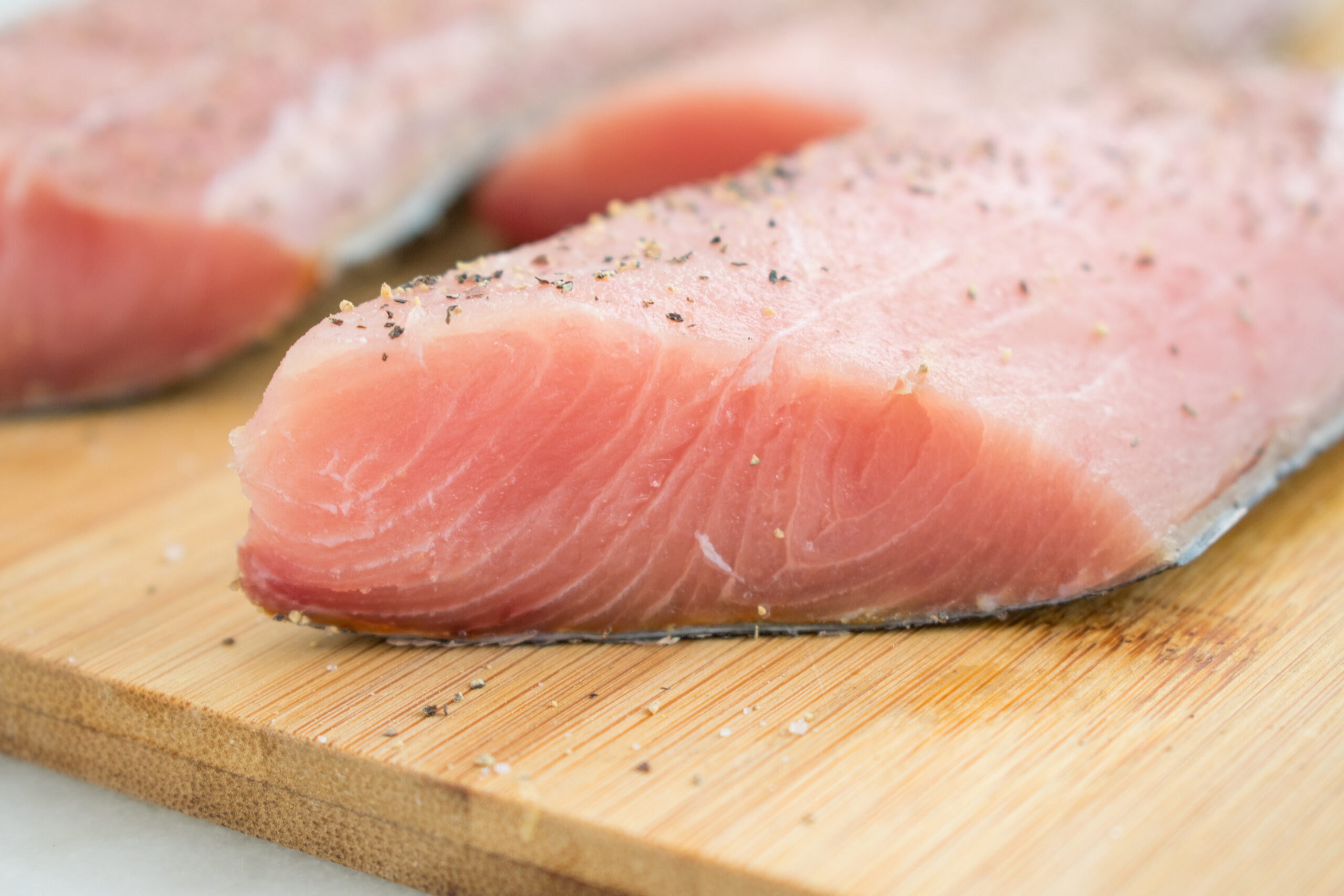 Raw Mahi Mahi (Dolphin Fish) Fillets on a Cutting Board
